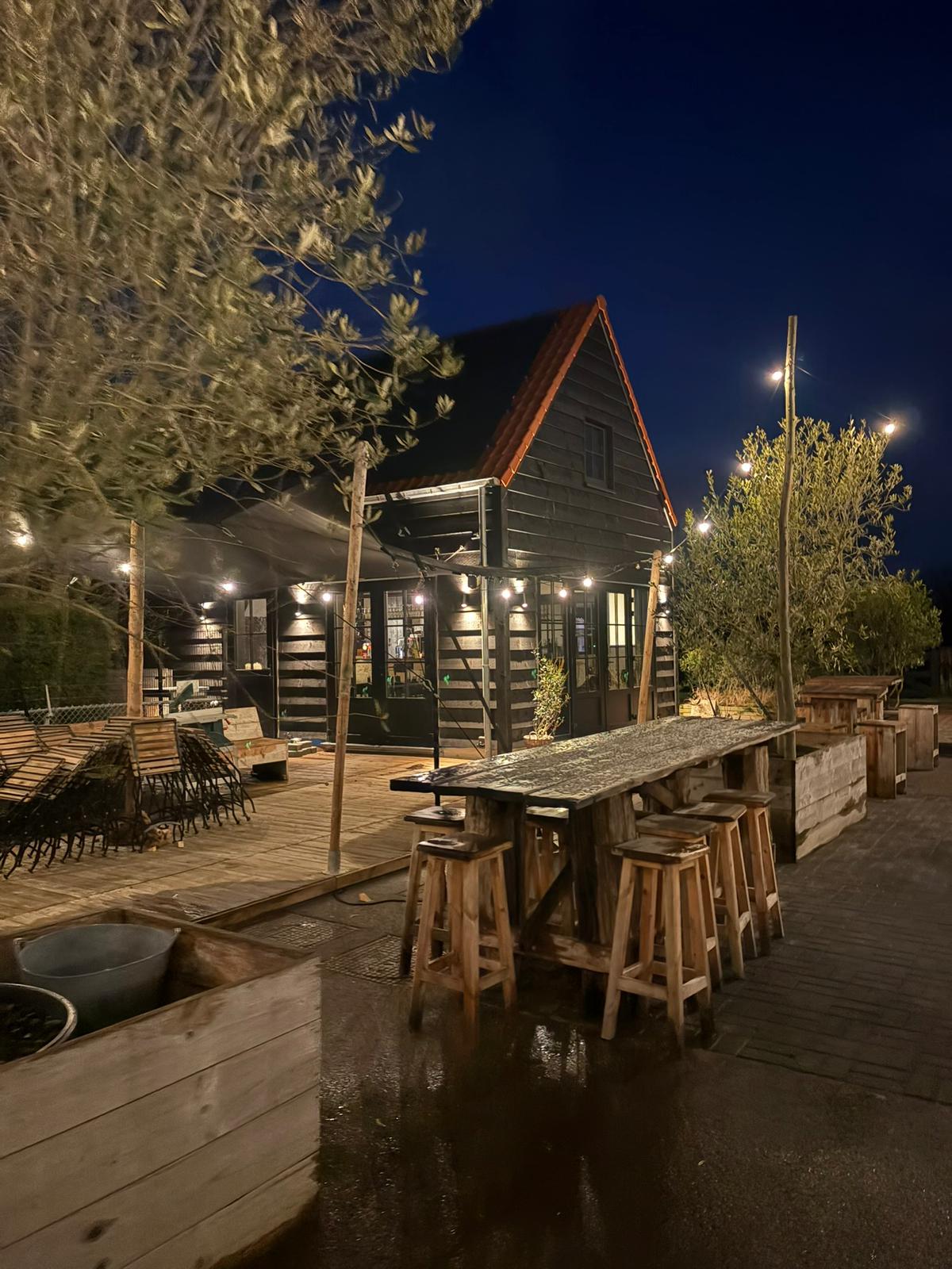 La Terrasse 364 in de avond, verlicht met sfeerlampjes onder een donkere lucht